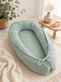 AnTalin Babynest Cord in Mintgrün, weiches Nestchen für Babys, mit gepolsterten Seiten und praktischem Design.