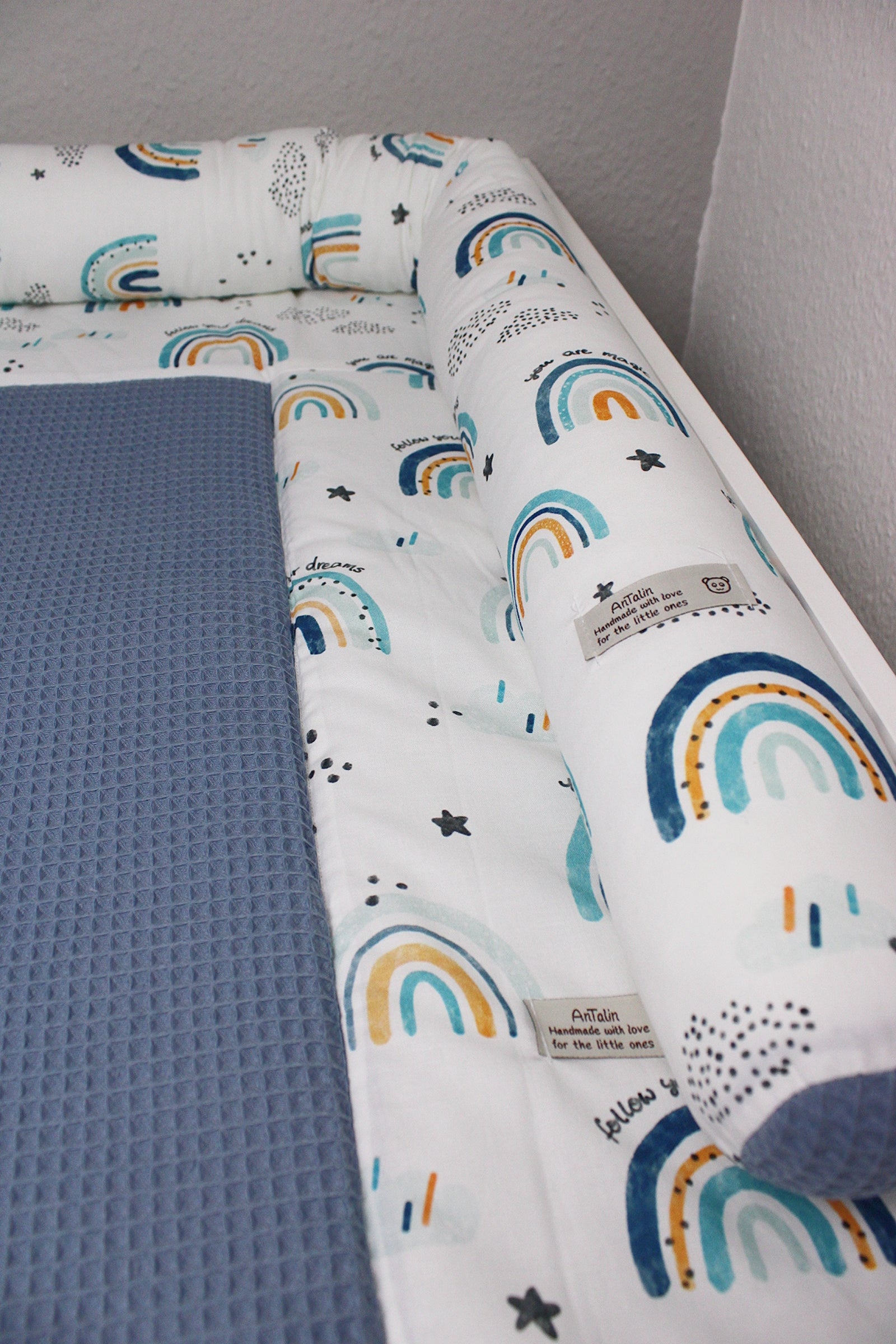 Blaue Wickeltischumrandung mit Regenbogenmuster von AnTalin, weiches Polster für sicheren Wickelplatz