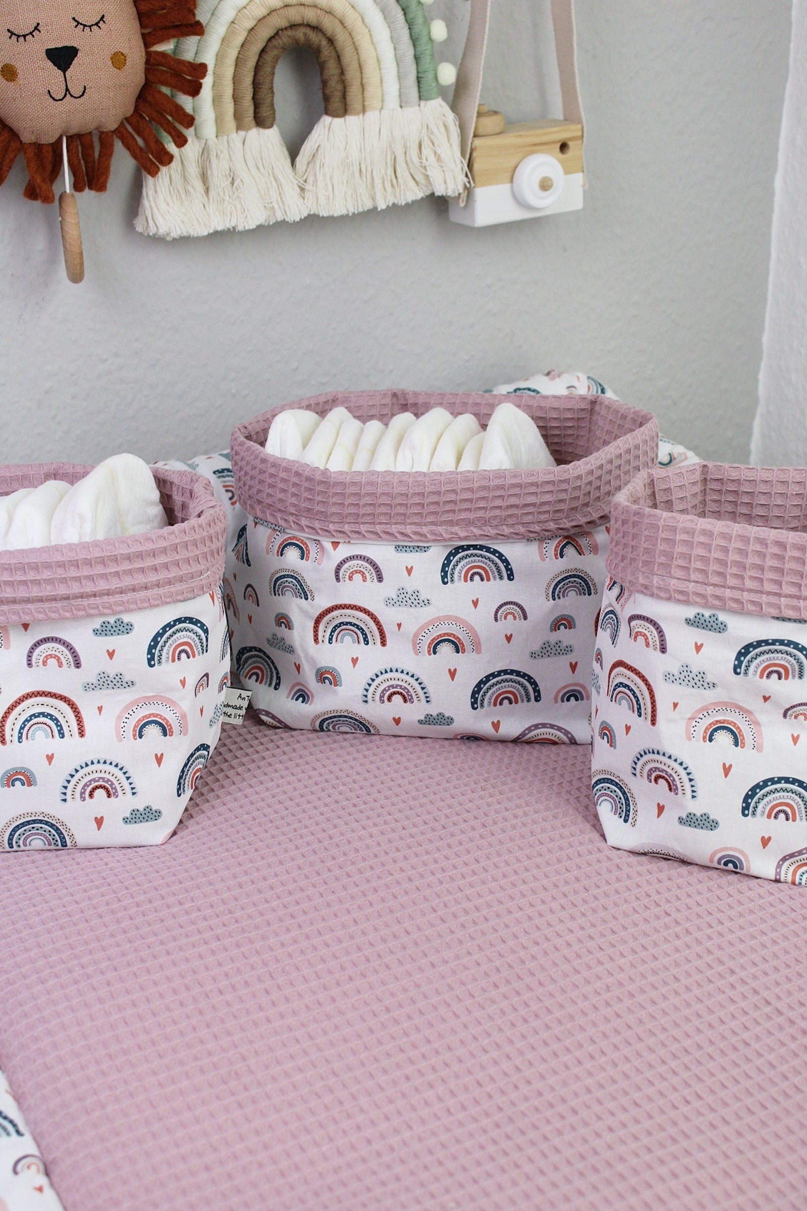 Pastellrosanes Regenbogen-Utensilo von AnTalin, aus Stoff, mit bunten Regenbogenmustern und Platz für Küchenutensilien.
